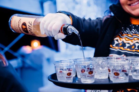 A bartender makes a drink at the ice bar.