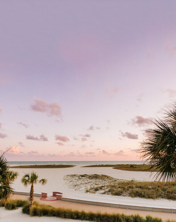 The wide stretch of beach on Treasure Island, Florida, at sunset.