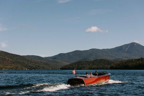 The custom Hacker Craft, Christie, plies the waters of Lake Placid.