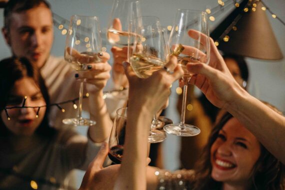 Friends raising wine glasses in a celebratory toast.