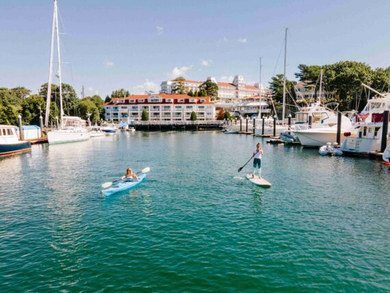 Two girls paddle through the waters of Little Harbor in New Castle.