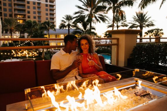 couple sitting by fire at sandpearl resort